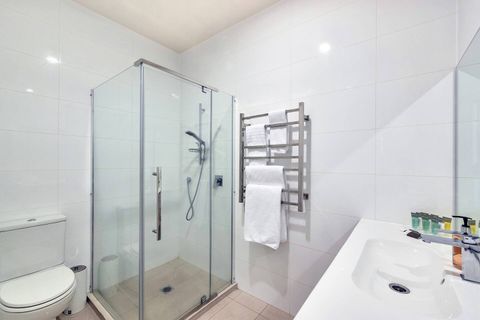 The bathroom is large and roomy, with heated towel rails, generous counter space and a big mirror.