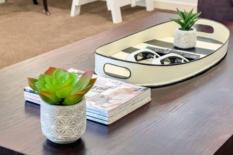 There are little details such as succulents, trays and magazines to make it feel more homely.