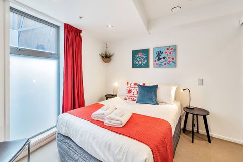 The bedroom has two bedside tables and modern lamps.