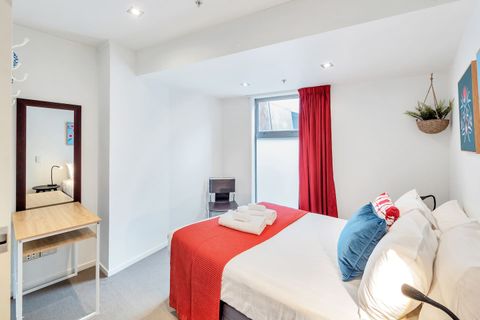 The artwork on the wall plays into the colour of the soft furnishings.