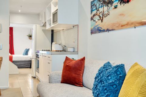 The soft furnishings echo the colours of the picture on the wall.