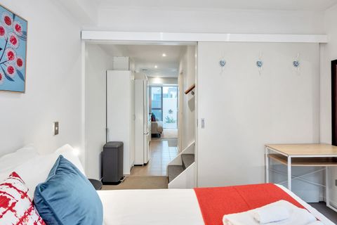 The downstairs bedroom has a Queen-sized bed with a sliding door for privacy.