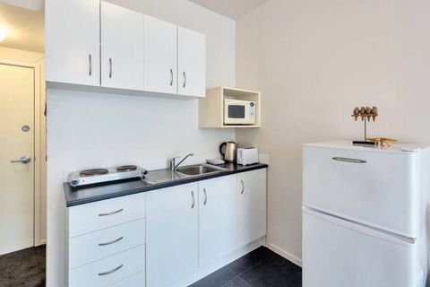 The kitchenette comes with basic cooking facilities, including a microwave and cooktop.