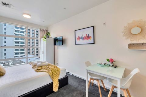 There is a free-standing wardrobe and wall-mounted TV.