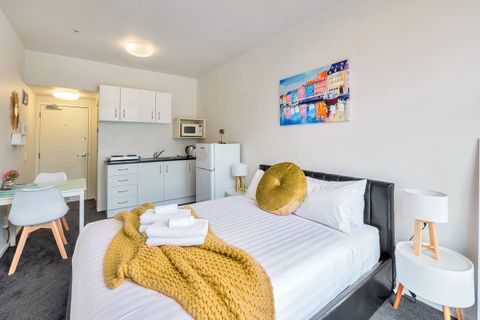 View of the studio unit that includes the bedroom, dining table and kitchenette area.