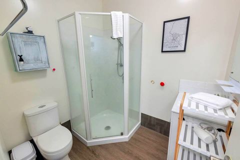 Fully equipped bathroom with shower cabinet, toilet, and vanity unit.