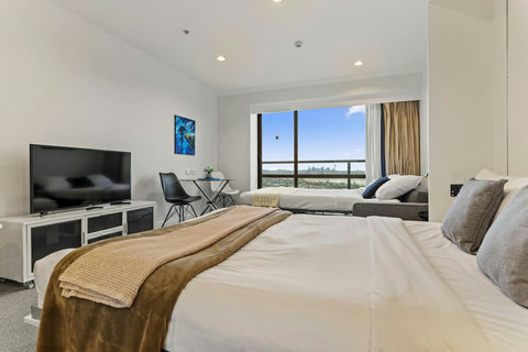 Lie in bed and enjoy watching TV.