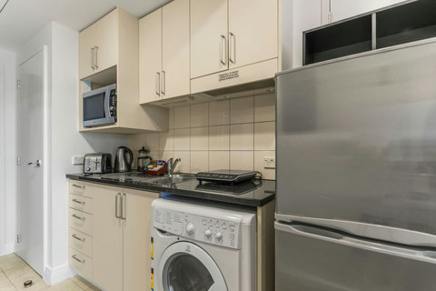 The combo washer and dryer are in the kitchenette area, handy for longer stays.