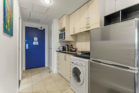Enter the apartment into the kitchenette area.