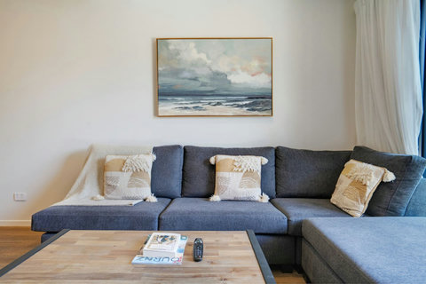 The couch looks like a comfortable place to relax and read a book or watch TV.