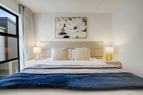 Pops of blue add some colour to this neutral toned bedroom.