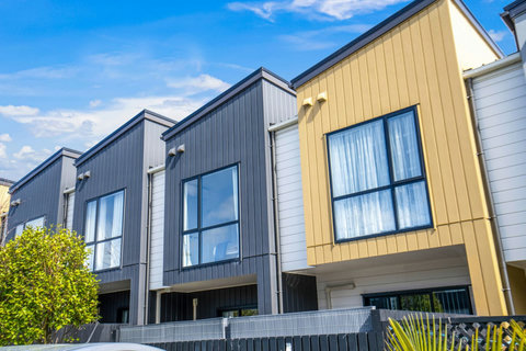 The townhouse is located amongst other similar houses.