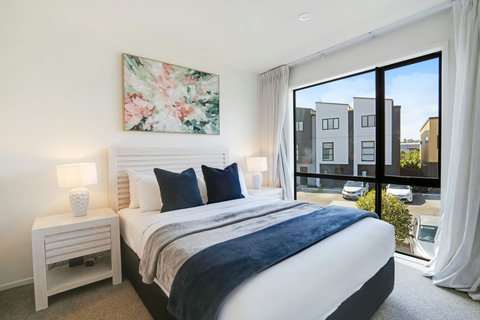 Enjoy the natural light from the floor-to ceiling windows in this bedrooms.