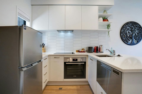 The kitchen has an oven, cook top, dishwasher, fridge/freezer and microwave.