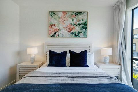 This bedroom has lovely bedside lamps and tables, handy for putting your stuff you need in bed.