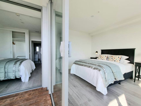 Two of the bedrooms open onto the covered balcony.