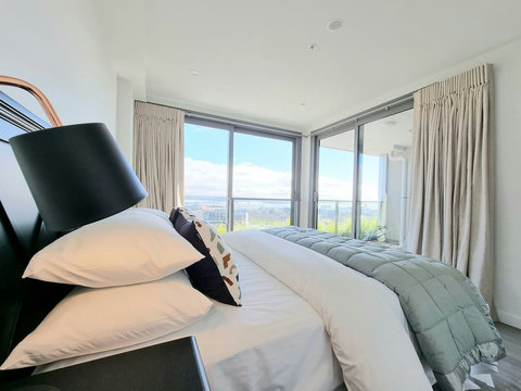 The main bedroom opens onto the covered balcony area.