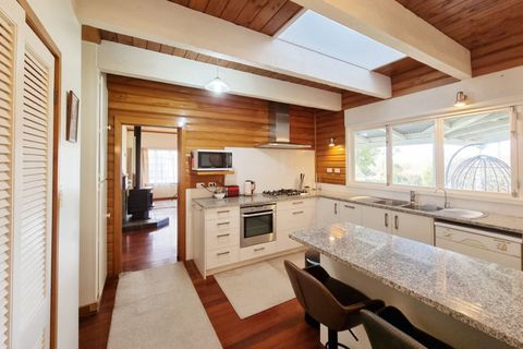 Large modern easy-care country kitchen with builtin oven, gas cooktop, microwave, twin sinks, dishwasher, fridge/freezer, large pantry and island bench with granite countertops.