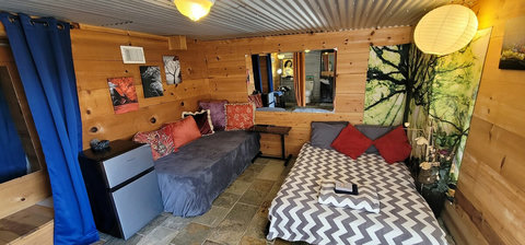 UPGRADE OPTION DEN
under patio Den only used for the 3rd & 4th persons. A bit rustic & simple accommodations vs the main cabin. An overflow room basically. Less than 10 steps from Cabin. 

Shower, Bathroom, Sink, Small Refrigerator, Spring Water. 