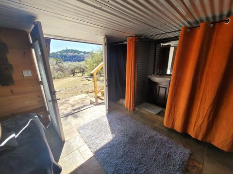 UPGRADE OPTION DEN
under patio Den only used for the 3rd & 4th persons. A bit rustic & simple accommodations vs the main cabin. An overflow room basically. Less than 10 steps from Cabin. 

Shower, Bathroom, Sink, Small Refrigerator, Spring Water. 