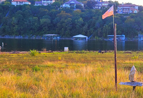 lakefront early September after 40 foot lake rise! MUCH fuller, but no more rock cliff. Our Dock was taken with flood and we just got another towed over and hooked up late 2025. Still needs some TLC, but still fully functional floating fun pad! 