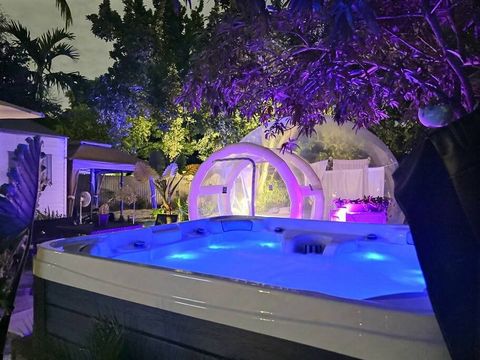 Tropical Oasis Jacuzzi & Glamping at night
