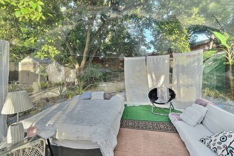 Queen bed and a sofa inside our glamping tent