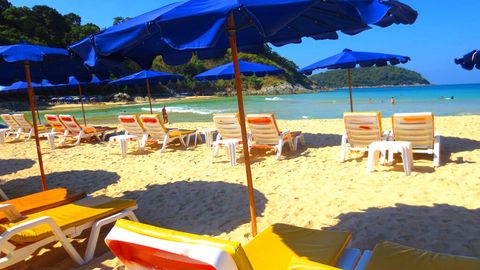 Nai Harn Beach. Here you can relax in the shade. Behind the beach, there are many bars where you can grab something to eat or drink a refreshing shake.