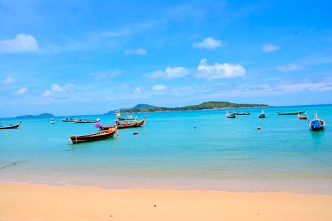 Rawai beach with  longtail boats and fishermen.