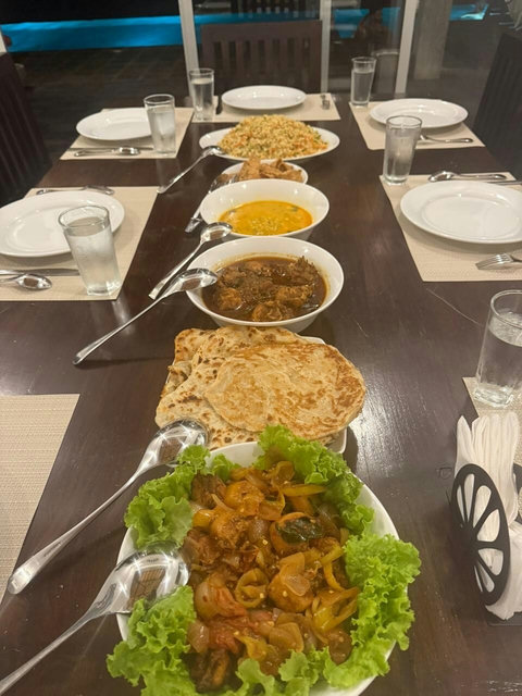 Enjoy a beautifully prepared dinner at Starflower Villa. A vibrant spread of Sri Lankan curries, roti, vegetables, and fragrant rice is served on an elegantly set table by the pool—perfect for a relaxed, chef-made meal with family or friends.