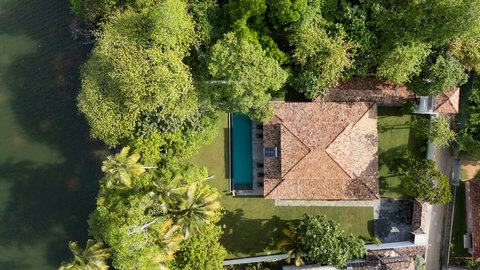 Bird’s-Eye Exterior View

An overhead view of the villa surrounded by tropical trees, with its long riverfront pool and peaceful garden creating the perfect private getaway.