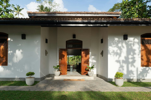 Entrance to StarFlower Villa- Front Entrance

A warm, welcoming entrance framed by wooden doors and lush greenery. Step inside to discover serene river views and airy, open spaces throughout the villa.