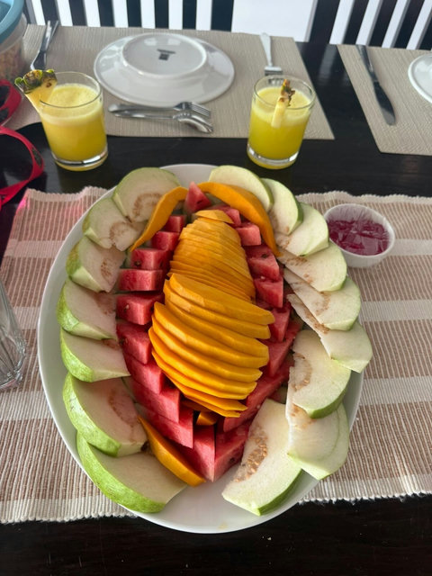 A fresh tropical fruit platter at Starflower Villa. Beautifully arranged slices of mango, watermelon, and guava are with chilled pineapple juice for a refreshing start to the day. It’s the perfect way to enjoy a bright, healthy morning by the villa.
