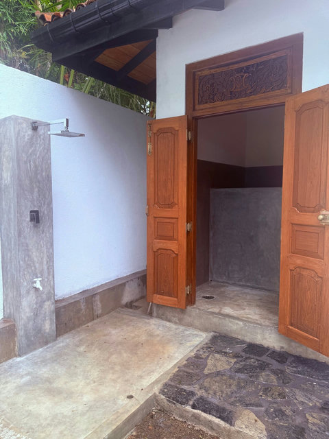 Outdoor Shower & Poolside Bathroom Entrance

A convenient outdoor shower and bathroom located just steps from the pool—perfect for rinsing off after a swim before heading inside.