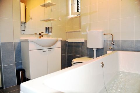 Bathroom 1 has a bathtub, sink and toilet