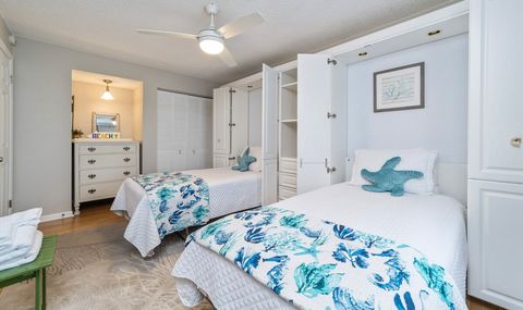 Two twin beds that can also be folded up (murphy beds) and the space used for a yoga studio.