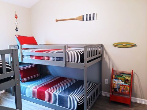 Third bedroom with lots of toys and books for kids.