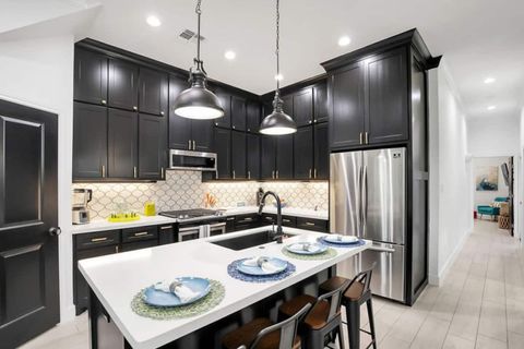 Stainless steel appliances, gas stove and large refrigerator.