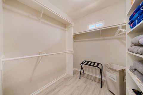 Huge master bedroom closet with ample towels and supplies.
