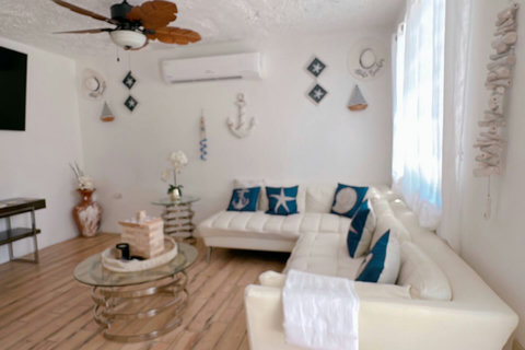 Living Room: Light-filled retreat with nautical decor perfect for unforgettable gatherings!