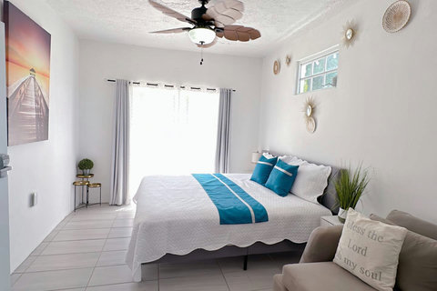 First Floor Master Bedroom: Bright and airy retreat with serene decor and plush furnishings!