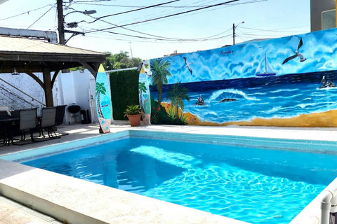 Outdoor Paradise: Splash into fun at your private pool, surrounded by vibrant murals and shade!
