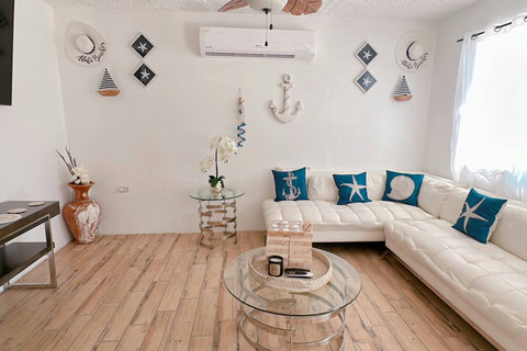 Living Room: Stylish retreat with nautical accents, plush lounge seating, and inviting natural light!