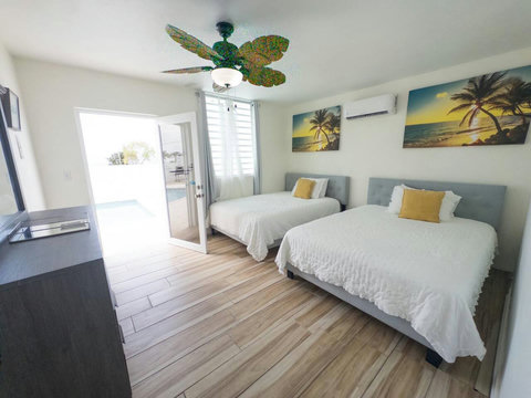Bedroom Retreat: Bright space with two queen beds, artful decor, and poolside access!