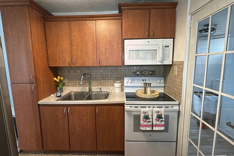 Kitchen: Whip up delicious meals in this stylish space with modern appliances and bright accents!
