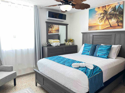 1st Bedroom: Relax in style with ocean views, 55" TV, and vibrant beach-themed decor!
