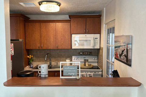 Kitchen Corner: Bright space with modern appliances and island seating for casual meals!