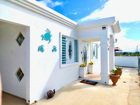 Welcoming Entrance: Bright and airy façade adorned with cheerful decor and coastal charm!