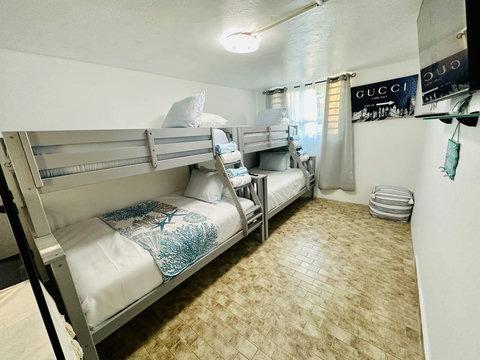 Bunk Room: Fun-filled getaway with stylish bunks, playful decor, and friendly vibes await!