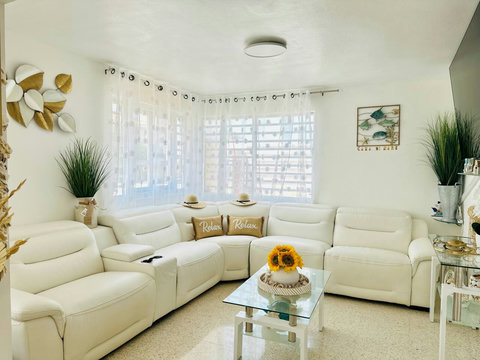 Living Room: Bright and airy space featuring a stylish sectional and cheerful decor, perfect for relaxation!